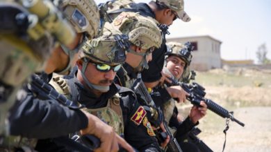 Iraqi Counter Terrorism troops inspect their weapons before conducting a cordon and search training exercise outside Mosul, Iraq