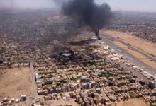 An aerial view shows black smoke rising above the Khartoum International Airport in Khartoum, Sudan